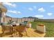 Outdoor patio set in a fenced backyard with green grass and flower boxes at 1755 Buckeye Rd, Davenport, FL 33837