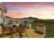 Serene backyard patio with comfortable seating and a picturesque sunset view perfect for outdoor relaxation at 1755 Buckeye Rd, Davenport, FL 33837