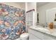 Cozy bathroom featuring a patterned shower curtain and a granite vanity at 1755 Buckeye Rd, Davenport, FL 33837