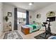 Cozy bedroom features a large window, stylish décor and personal exercise equipment at 1755 Buckeye Rd, Davenport, FL 33837