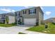 Charming two-story home with a well-maintained lawn and a two-car garage at 1755 Buckeye Rd, Davenport, FL 33837