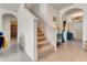 Bright hallway with stairs, tile floors, and stylish decor at 1755 Buckeye Rd, Davenport, FL 33837