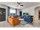 Bright living room with stylish furnishings, TV, decorative curtains, and tile flooring at 1755 Buckeye Rd, Davenport, FL 33837