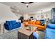 Open concept living room showcasing multiple sofas, modern decor, and an island with barstool seating at 1755 Buckeye Rd, Davenport, FL 33837