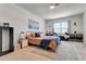 Bright main bedroom featuring a plush bed, window nook, and stylish decor at 1755 Buckeye Rd, Davenport, FL 33837