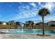 Gorgeous neighborhood pool, featuring lounge chairs, water features, and a pristine blue swimming area at 1755 Buckeye Rd, Davenport, FL 33837