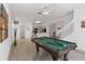 Bright game room with a pool table, open to the kitchen and staircase at 238 N Hampton Dr, Davenport, FL 33897