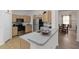 Kitchen featuring stainless steel appliances, light wood cabinets, and a breakfast bar at 238 N Hampton Dr, Davenport, FL 33897