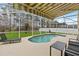 Backyard pool inside of a screened enclosure with an awning and lots of space for chairs at 238 N Hampton Dr, Davenport, FL 33897