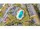 Aerial view of the community pool surrounded by lush landscaping, buildings and parking at 2424 Barley Club Ct # 8, Orlando, FL 32837