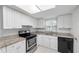 Well-lit kitchen featuring granite countertops, white cabinets, and modern stainless steel appliances at 2424 Barley Club Ct # 8, Orlando, FL 32837