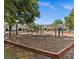 Community playground with a variety of equipment for children to enjoy, nestled in a wooded area at 2424 Barley Club Ct # 8, Orlando, FL 32837
