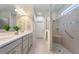 Modern bathroom featuring double vanity, walk-in shower, and neutral tile at 246 Tomelloso Way, Davenport, FL 33837