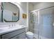 Well lit bathroom with a stylish vanity, decorative mirror and a glass enclosed shower with neutral tile at 246 Tomelloso Way, Davenport, FL 33837
