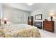 Bedroom with a floral patterned bedspread and shuttered window at 246 Tomelloso Way, Davenport, FL 33837