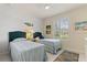 Bright bedroom with twin beds, ceiling fan, and natural light from the window at 246 Tomelloso Way, Davenport, FL 33837