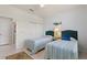 Bright bedroom featuring twin beds with striped bedding, tile flooring, and coastal-themed decor at 246 Tomelloso Way, Davenport, FL 33837