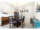 Dining room with wood table set and cabinet with wine rack, and a sunny window at 246 Tomelloso Way, Davenport, FL 33837