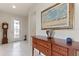 Inviting entryway featuring tile flooring, wooden furniture, and art decorations at 246 Tomelloso Way, Davenport, FL 33837