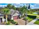 Charming single-Gathering home features a paver driveway, two car garage and tropical landscaping at 246 Tomelloso Way, Davenport, FL 33837