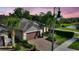 Charming single-Gathering home features a paver driveway, two car garage and tropical landscaping at 246 Tomelloso Way, Davenport, FL 33837