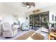Bright Florida room with sliding glass doors that lead to the outside screened in patio and tropical landscape at 246 Tomelloso Way, Davenport, FL 33837