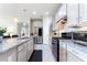 Well-lit kitchen featuring granite countertops, stainless steel appliances, and ample cabinetry at 246 Tomelloso Way, Davenport, FL 33837
