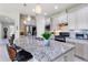 Modern kitchen features white cabinets, granite countertops, and stainless steel appliances at 246 Tomelloso Way, Davenport, FL 33837