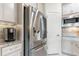Modern kitchen with stainless steel refrigerator, microwave, and granite countertops at 246 Tomelloso Way, Davenport, FL 33837