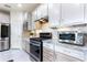 Updated kitchen boasts stainless steel appliances, granite countertops, and stylish tile backsplash at 246 Tomelloso Way, Davenport, FL 33837
