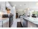 Bright kitchen with stainless steel appliances, granite counters, and mosaic tile backsplash at 246 Tomelloso Way, Davenport, FL 33837