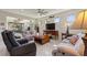 Bright living room with a ceiling fan, tile flooring and view of the screened in patio at 246 Tomelloso Way, Davenport, FL 33837