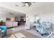 Bright living room with tile flooring, neutral walls, coastal decor, and comfortable seating arrangements at 246 Tomelloso Way, Davenport, FL 33837