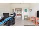Bright office with a desk station and views into an adjacent living area with colorful decor at 246 Tomelloso Way, Davenport, FL 33837