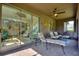 Outdoor seating area with brick flooring, ceiling fan, and view of the backyard at 246 Tomelloso Way, Davenport, FL 33837