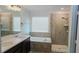 Bathroom features double vanity, soaking tub, walk-in shower, and neutral color palette at 3199 Turret Dr, Kissimmee, FL 34743