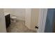Bathroom featuring tile floors, black vanity, toilet, and bathtub at 3199 Turret Dr, Kissimmee, FL 34743