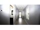 Hallway with bathroom and view of the entryway through the front door at 3199 Turret Dr, Kissimmee, FL 34743