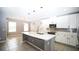 Spacious kitchen with island sink, pendant lights, and stainless steel appliances at 3199 Turret Dr, Kissimmee, FL 34743