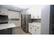Modern kitchen boasts stainless steel refrigerator and ample white cabinetry at 3199 Turret Dr, Kissimmee, FL 34743