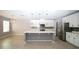 Bright kitchen features white cabinets, stainless steel appliances, and a large island at 3199 Turret Dr, Kissimmee, FL 34743