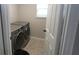 Convenient laundry room with modern washer and dryer on neutral tile and next to a window at 3199 Turret Dr, Kissimmee, FL 34743