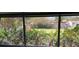 View of backyard showcasing lush greenery, a shed, and a wooden fence at 332 Carolina Ave, St Cloud, FL 34769