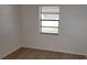 An empty bedroom featuring a window and laminate flooring at 332 Carolina Ave, St Cloud, FL 34769