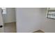 A bedroom featuring painted white walls, laminate flooring, and a large window at 332 Carolina Ave, St Cloud, FL 34769