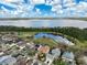 Stunning aerial view showcasing a residential area with a scenic lake and walking trails at 3329 Schoolhouse Rd, Harmony, FL 34773