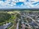 Overhead view highlighting the community's layout, with a central park, winding paths, and homes with private pools and scenic views at 3329 Schoolhouse Rd, Harmony, FL 34773