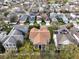 Aerial view of a home with a brown roof, surrounded by lush greenery and other houses in a suburban neighborhood at 3329 Schoolhouse Rd, Harmony, FL 34773