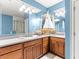 A large bathroom featuring dual sinks, a shower, and nautical decorations at 3329 Schoolhouse Rd, Harmony, FL 34773