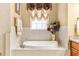 Bright bathroom featuring a soaking tub and a large window at 3329 Schoolhouse Rd, Harmony, FL 34773